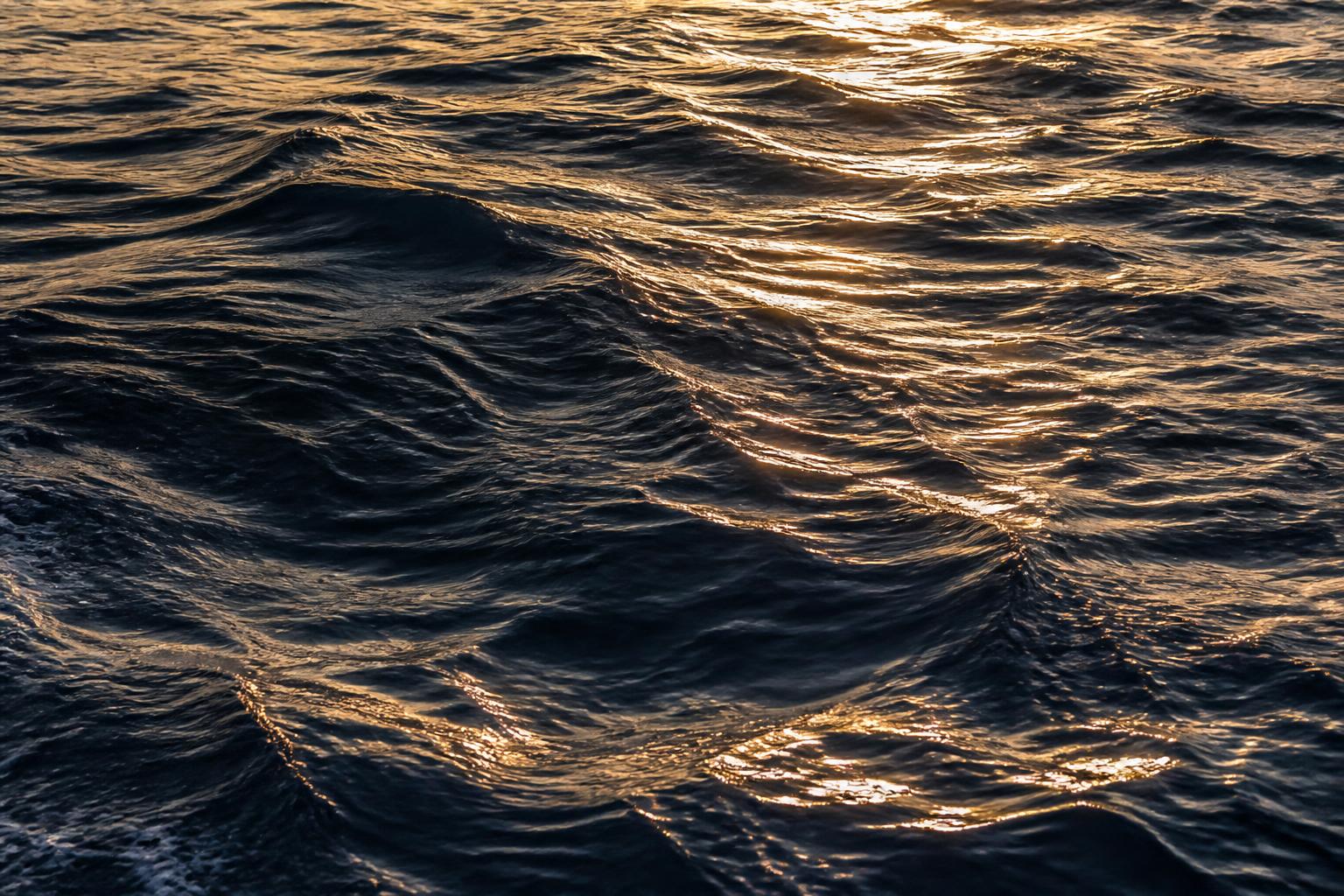 Golden light rippling across ocean water